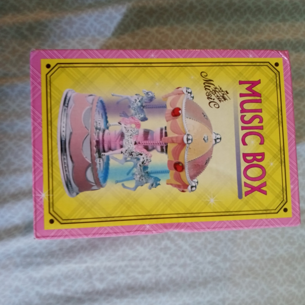 Pink and yellow moving music box with light